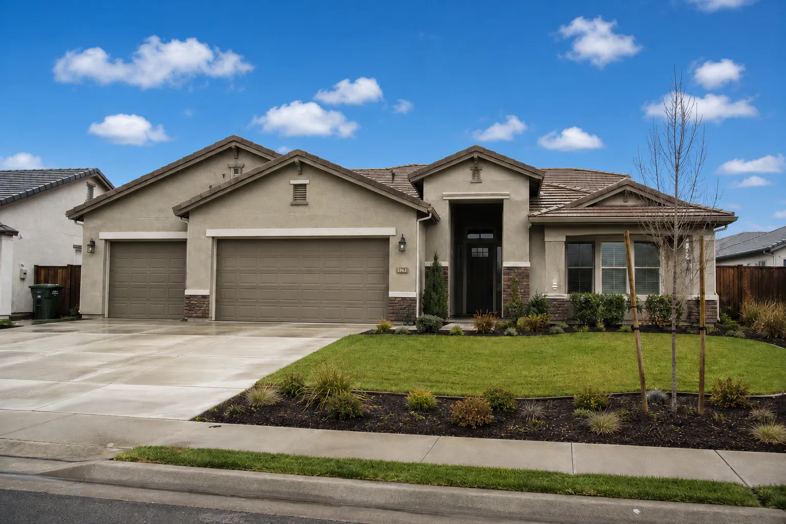 Same house exterior after sky replacement with a blue sky and light clouds